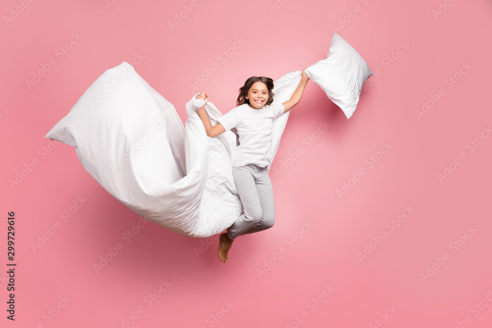 Full length body size view of nice attractive cute playful cheerful cheery wavy-haired pre-teen girl jumping flying with soft cotton pillow blanket isolated over pink pastel color background - obrazy, fototapety, plakaty 