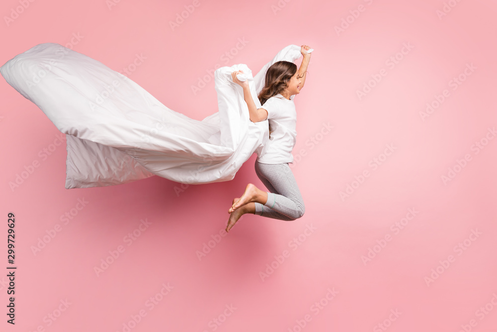 Full length body size view of nice attractive childish playful carefree cheerful cheery wavy-haired pre-teen girl jumping flying with blanket ghost isolated over pink pastel color background - obrazy, fototapety, plakaty 