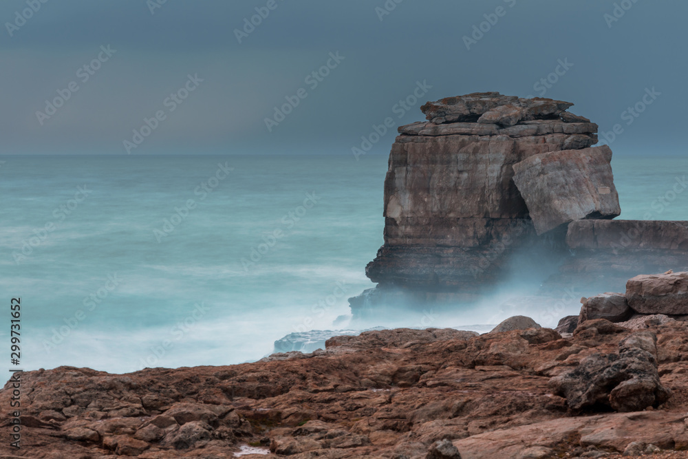 Portland.Dorset.EnglandPulpit Rock, One of Dorset's Jurassic Coast's most famous landmarks, during stormy weather.