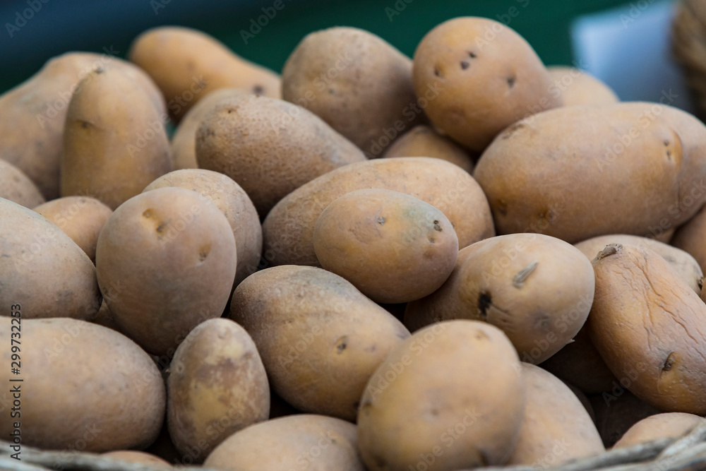 Raw potatoes in baskets on the market close up shot Raw potatoes in baskets on the market close up shot