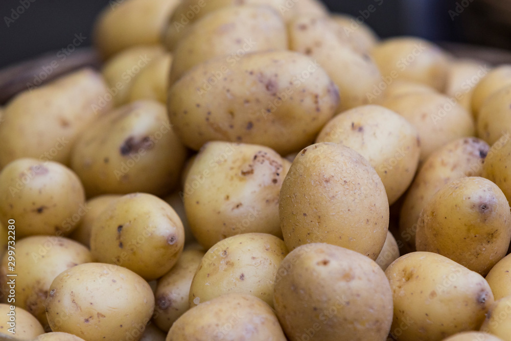 Raw potatoes in baskets on the market close up shot Raw potatoes in baskets on the market close up shot