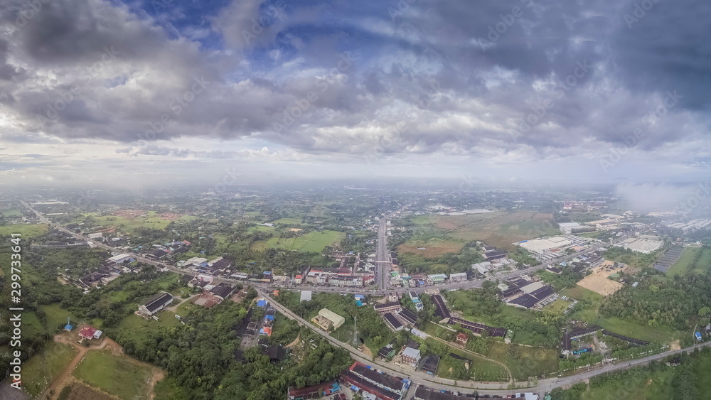 Aerial view panorama above urban, roads and many house with cloudy sky background, Nong Kob District, Ban Pong, Ratchaburi, Thailand.