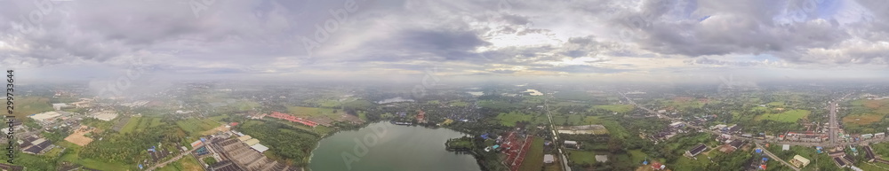 Obraz premium Aerial view panorama 360 degree above reservoir, urban, roads, rice fields and many house with cloudy sky background, Krajub reservoir, Nong Kob, Ban Pong, Ratchaburi, Thailand.