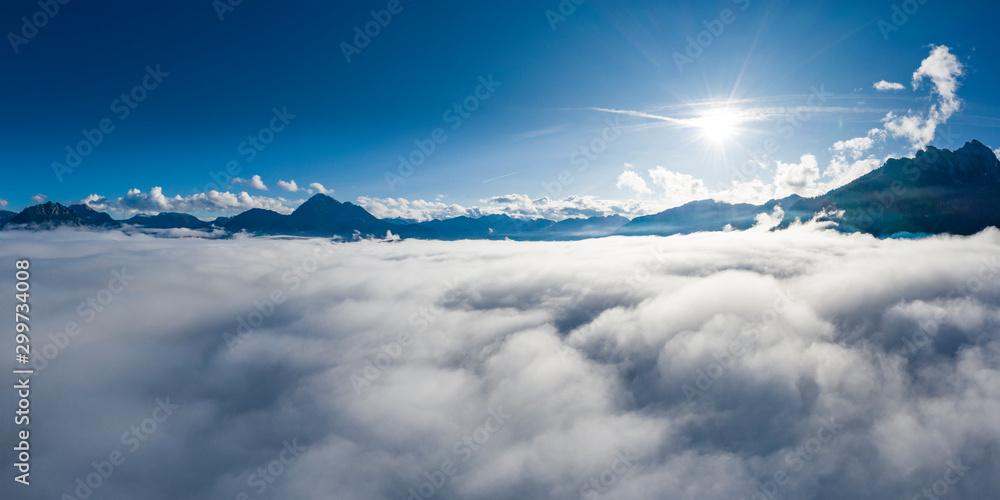 landscape with sun beams in alps of reutte above cloud bank