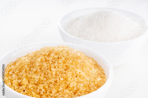 Brown cane and white granulated sugar in white rosettes