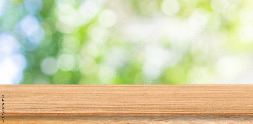 abstract blur green nature at park in the morning with wood table perspective for shwo,ads,banner and promote content or product on image concept abstract blur green nature at park in the morning with wood table perspective for shwo,ads,banner and promote content or product on image concept