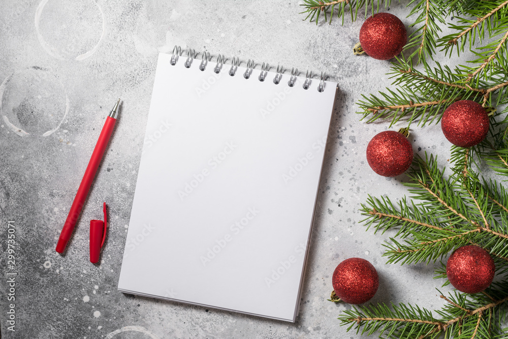 Christmas or New year holiday background with open blank Notepad, fir branches and Christmas traditional decorations. Top view with copy space Christmas or New year holiday background with open blank Notepad, fir branches and Christmas traditional decorations. Top view with copy space