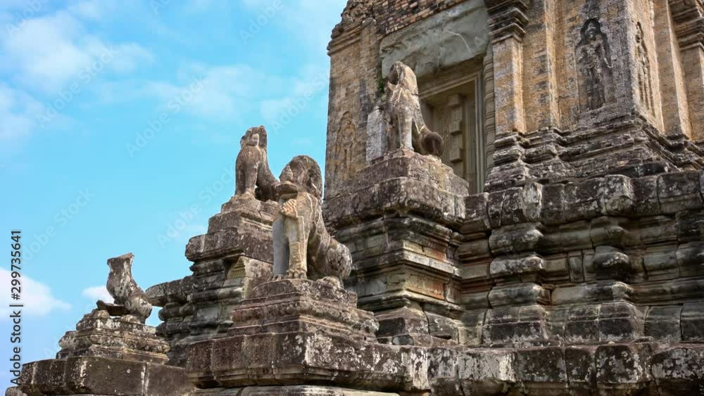 4K, Stone Lion Guardian along the stairway with blue sky and clouds at Pre Rup, The East Baray. General sight and statues of vigilant lions at the archaeological temple in Siam Reap, Cambodia.-Dan 4K, Stone Lion Guardian along the stairway with blue sky and clouds at Pre Rup, The East Baray. General sight and statues of vigilant lions at the archaeological temple in Siam Reap, Cambodia.-Dan