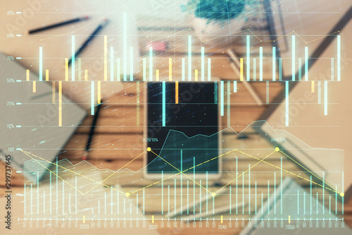 Double exposure of forex graph on digital tablet laying on table background. Concept of market analysis © Andrey