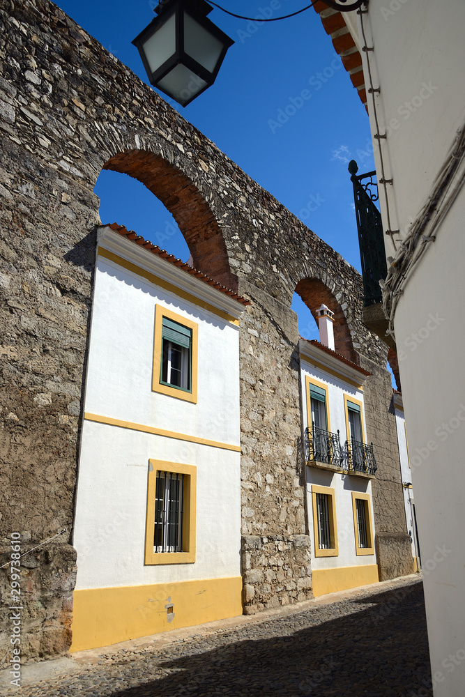 Architecture of houses built on the arches of the aqueduct, City of Evora, Portugal