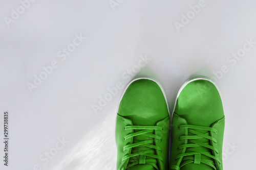 Green winter sneakers on a white background, close-up. copyspase