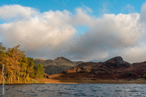 Morning light at Blea Tarn in the English Lake District with views of the Langdale Pikes, and Side Pike during autumn. photo