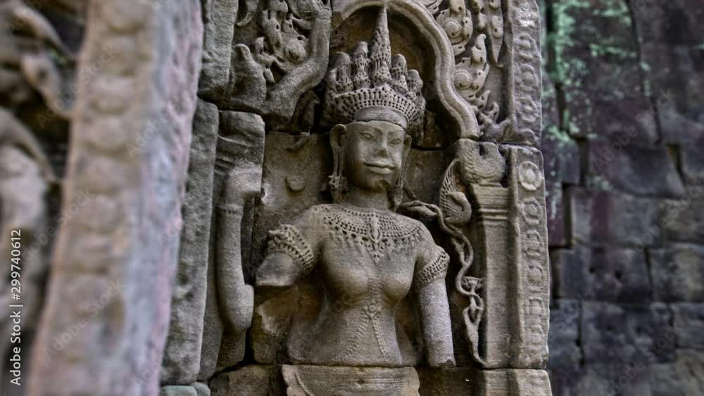 4K, Carved structures in Preah Khan. Ancient carvings adorn the temple walls of world-heritage site Angkor Thom. Bas reliefs and stone sculpture on the building of Khmer empire. Ruins of Cambodia.-Dan 4K, Carved structures in Preah Khan. Ancient carvings adorn the temple walls of world-heritage site Angkor Thom. Bas reliefs and stone sculpture on the building of Khmer empire. Ruins of Cambodia.-Dan