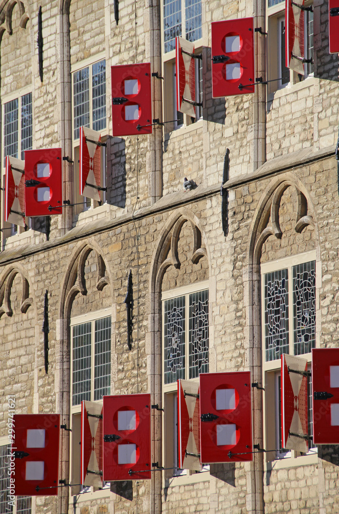 Obraz premium Gouda, Netherlands - October 28, 2019: Facade with windows and red shutters of Town Hall on Market Square in Gouda, Netherlands.