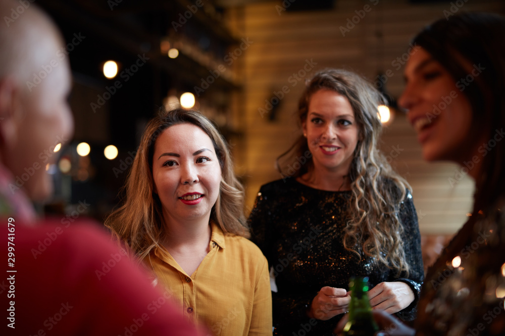 Group of friends drinking beer, chatting and having good time at pub. Night out. Group of friends drinking beer, chatting and having good time at pub. Night out.