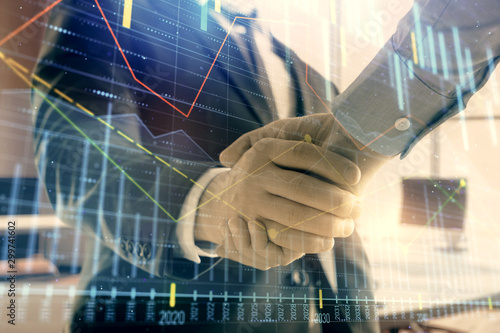 Multi exposure of financial graph on office background with two businessmen handshake. Concept of success in business