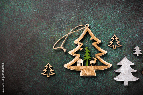 Overhead shoot of wooden christmas tree and decoration. Winter holidays background with copy space, flat lay, top view.