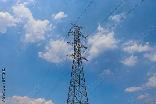 High-voltage power pylon under blue sky