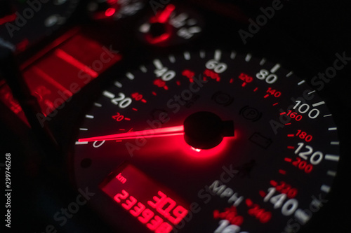 car dashboard. Speedometer with red backlight at night close up