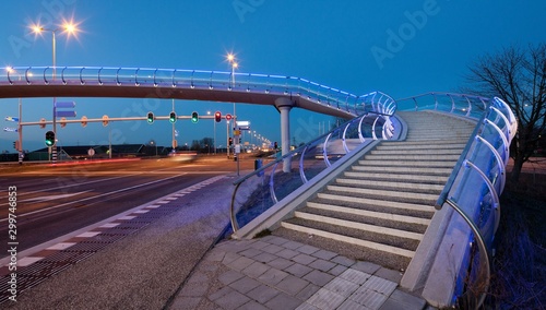 Modern Dutch architecture. Glass pedestrian bridge Barendrecht. Stairs. Evening. Twilight