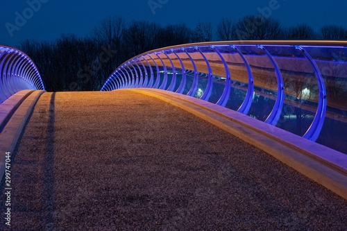 Modern Dutch architecture. Glass pedestrian bridge Barendrecht. Stairs. Evening. Twilight photo