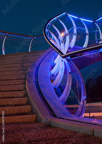 Modern Dutch architecture. Glass pedestrian bridge Barendrecht. Stairs. Evening. Twilight photo