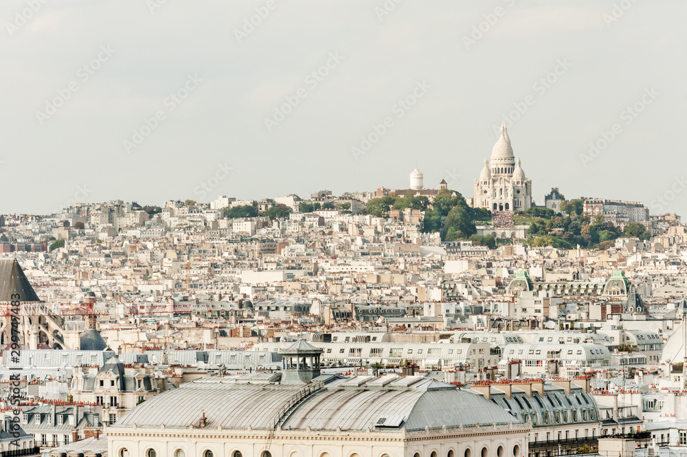 Typical Paris architecture and Basilique Sacre-Coeur on Montmartre Hill, the highest point of Paris, France