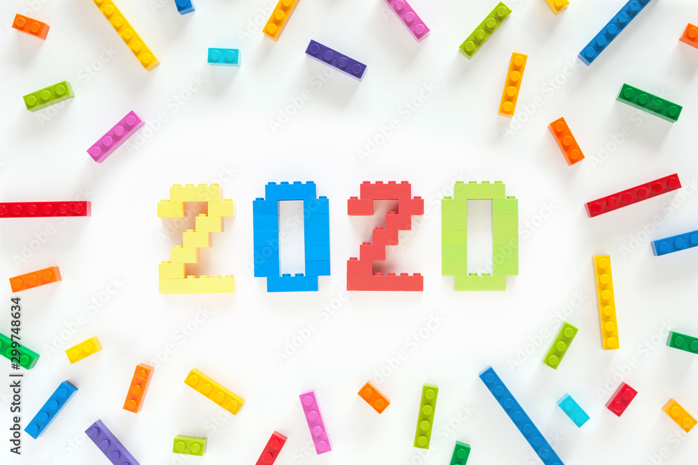 Numbers 2020 made from toys blocks with scattered blocks on white background Numbers 2020 made from toys blocks with scattered blocks on white background