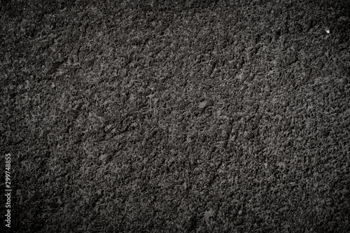 Texture of volcanic dark stone with rough surface