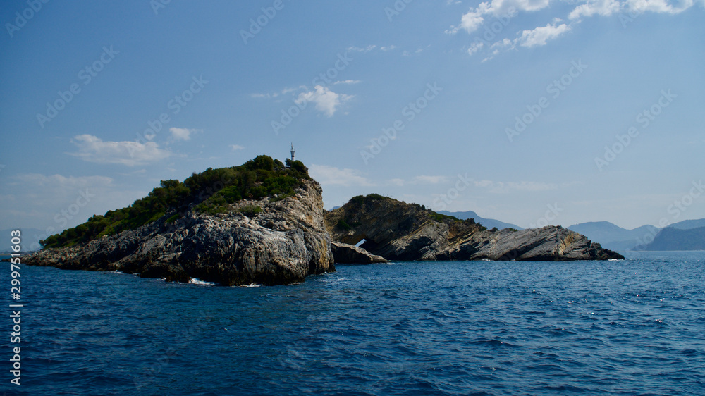 Rocky island with hole in the middle of the sea