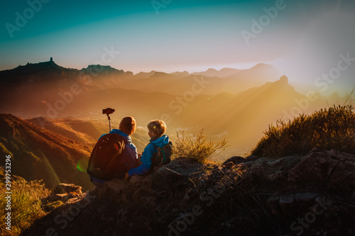 father with son making selfie in mountains  family travel