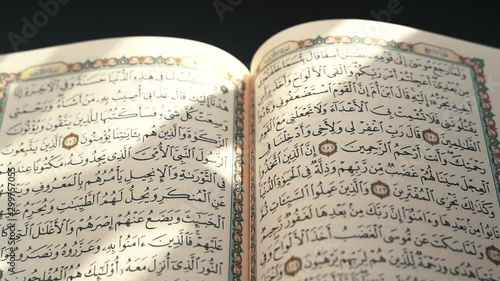 the holy Quran muslim holy book in black background , detail of Quran surah . Muslim lifestyle , arabic calligraphy 
