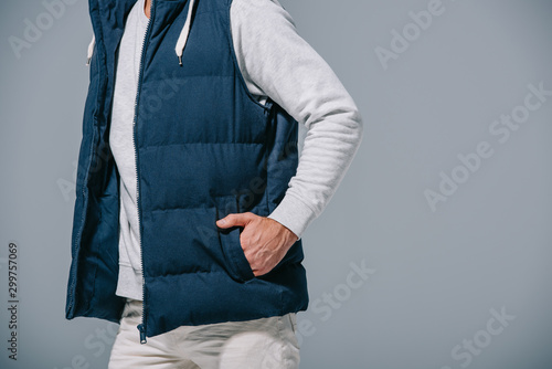 Obraz na plátně cropped view of man posing in autumn waistcoat, isolated on grey