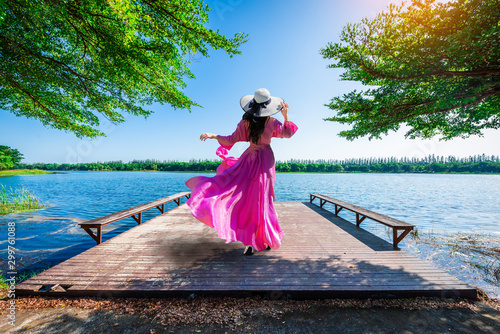 Young tourist stands on Nong Han Pier. Near the lotus garden in Sakon Nakhon Province,Thailand. photo