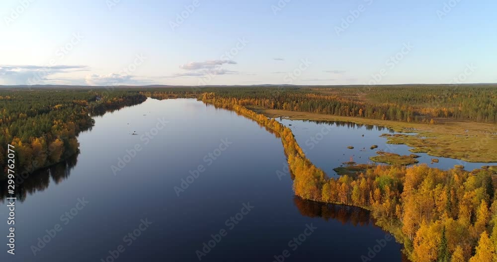 River in Lapland, Aerial, tracking, drone shot, panning around a esker on the Almansuvanto stream, surrounded by foliage color forest at golden hour, on a sunny, fall evening, in Sodankyla, Finland River in Lapland, Aerial, tracking, drone shot, panning around a esker on the Almansuvanto stream, surrounded by foliage color forest at golden hour, on a sunny, fall evening, in Sodankyla, Finland