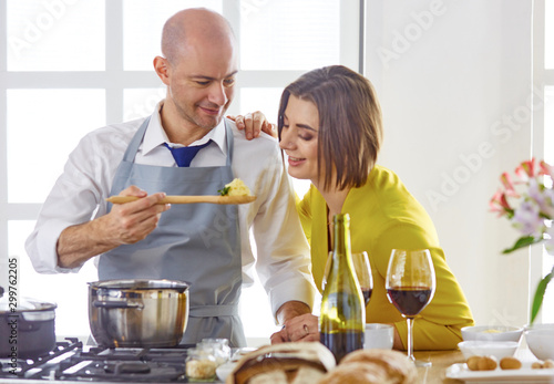 Smiling young couple cooking food in the kitchen