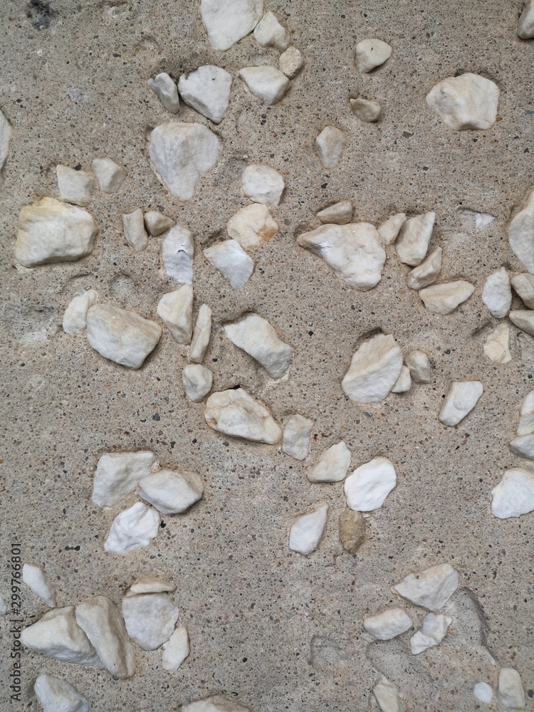 A lot of large white pebbles in porous gray concrete, texture A lot of large white pebbles in porous gray concrete, texture