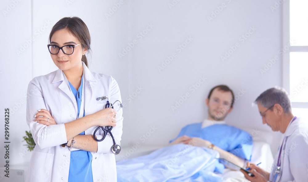 Doctor checking heart beat of patient in bed with stethoscope Doctor checking heart beat of patient in bed with stethoscope