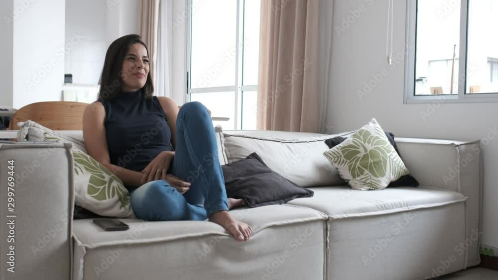woman using cellphone lying on sofa woman using cellphone lying on sofa