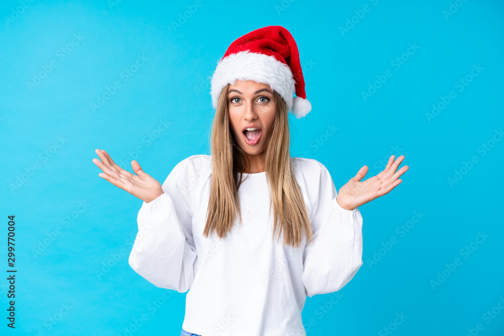 Girl with christmas hat over isolated background with surprise facial expression Girl with christmas hat over isolated background with surprise facial expression