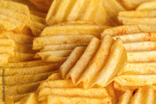 slices of fried potato curly chips, beautiful background for layout or text