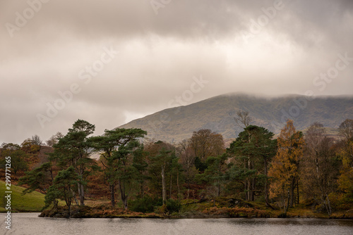 Morning light at Tarn Hows in the English Lake District with views of Yewdale Crag  and Holme Fell during autumn.