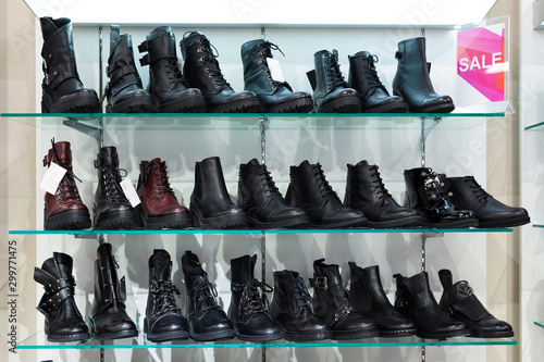 Glass shelves with black man's shoes in a shop