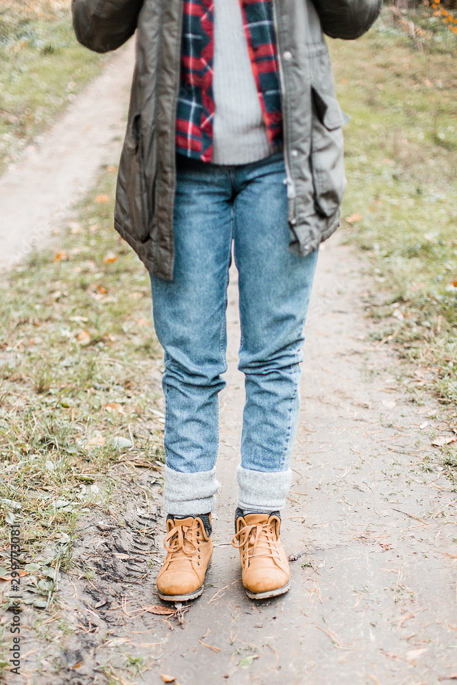 Hiking and travel along in the forest. Concept of trekking, adventure and seasonal vacation. Young woman walking in woods.