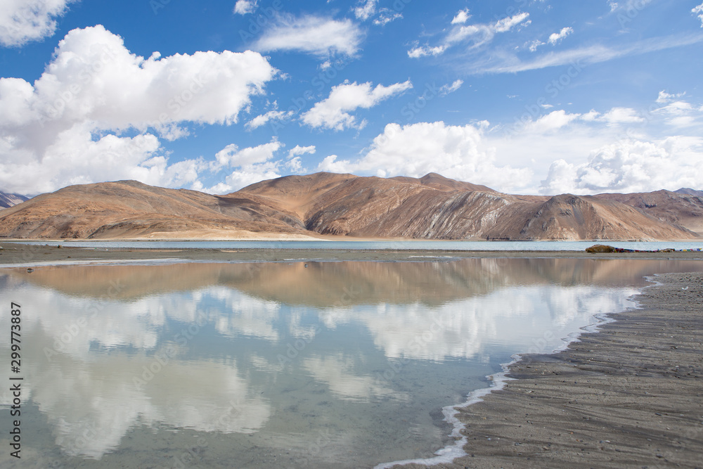 Pangong Lake with mountain, turquoise water ,clear blue sky and reflection of sky on water , Leh Ladakh, India