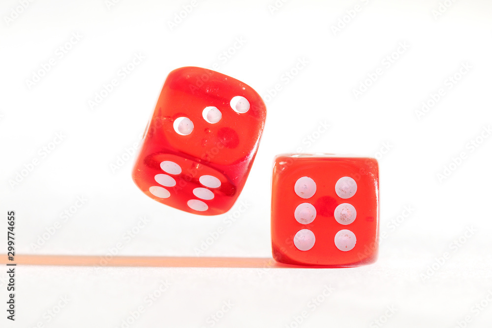 Two red dice, one moving, one static on white background Two red dice, one moving, one static on white background