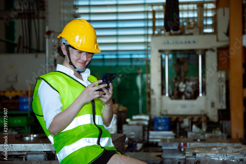 Mid section portrait of unrecognizable factory worker using digital tablet while operating modern machines in workshop, copy space