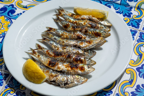 Fototapeta Naklejka Na Ścianę i Meble -  Espeto, Malaga style fish on stick barbecue prepared on olive tree firewoods