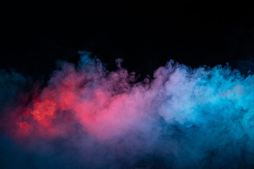 Abstract texture of backlit smoke in red blue on a black background.
