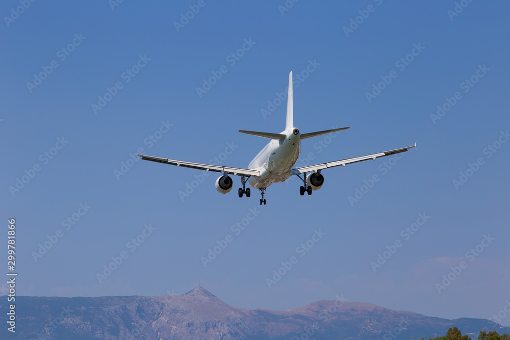Passenger airplane in the sky close-up. Decrease in height. Greece, Corfu. Passenger airplane in the sky close-up. Decrease in height. Greece, Corfu.